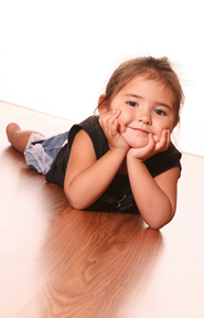 Girl on heated hardwood floor.